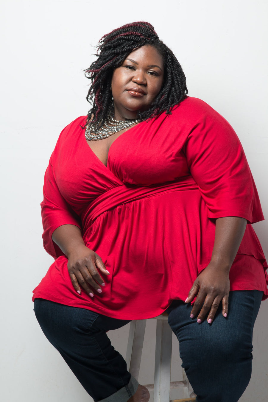 An earlier chapter: Dr. Shermnae D. Jones in a red top and statement necklace