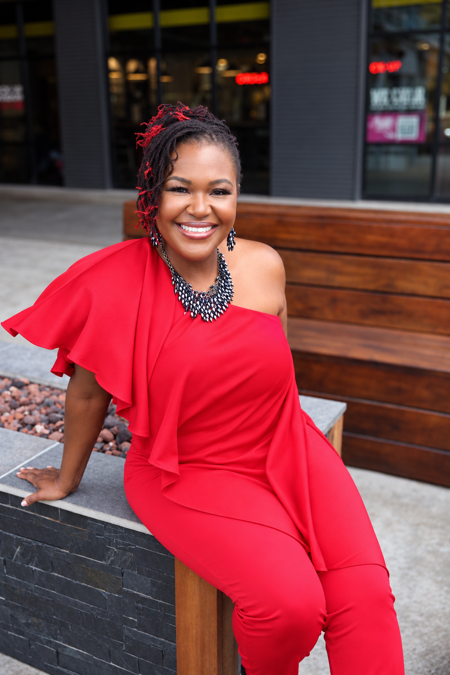 The evolution: Dr. Shermnae D. Jones in a red one-shoulder outfit